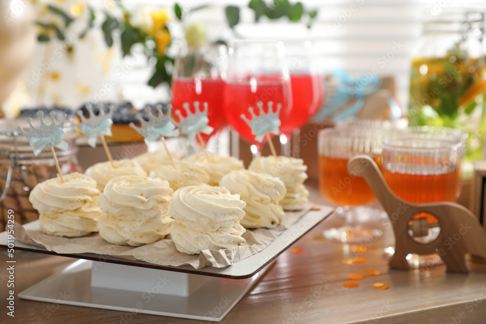 Delicious party treats on wooden table indoors