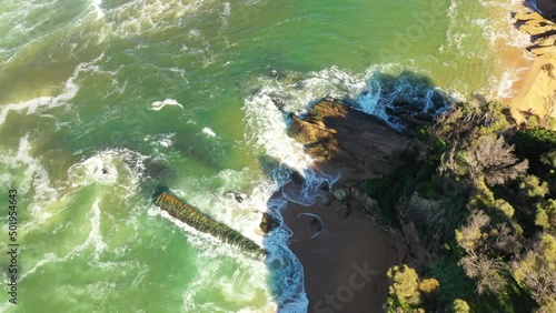 Bega river stream entrance to Pacific ocean at Tathra beach – aerial above.
 photo
