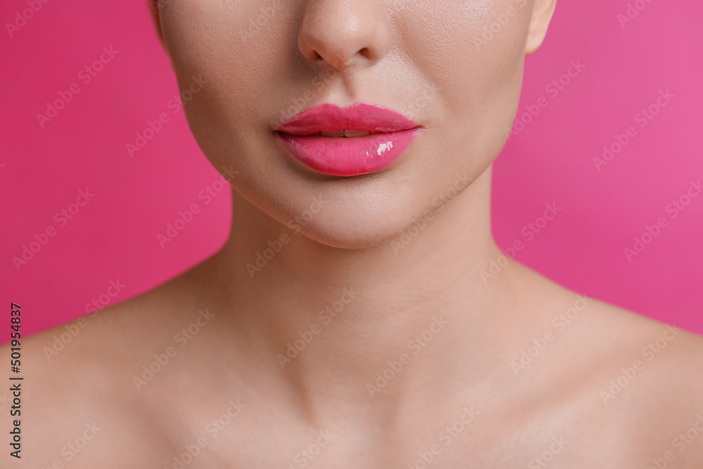 Closeup view of woman with beautiful lips on pink background Closeup view of woman with beautiful lips on pink background
