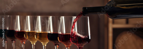Obraz na płótnie Pouring wine from bottle into glass. Banner design