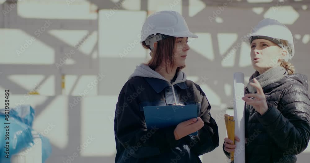 Young female architect gesturing while explaining to engineer Young female architect gesturing while explaining to engineer