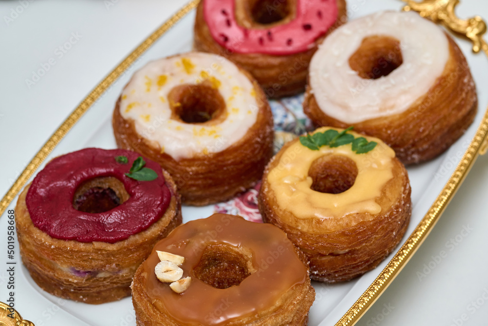 a plate with different donuts that have different glazes - Delicious fresh donuts on a plate 