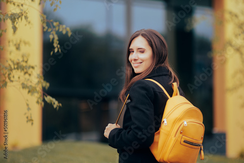 Cheerful Woman with Yellow Backpack Smiling at the Camera