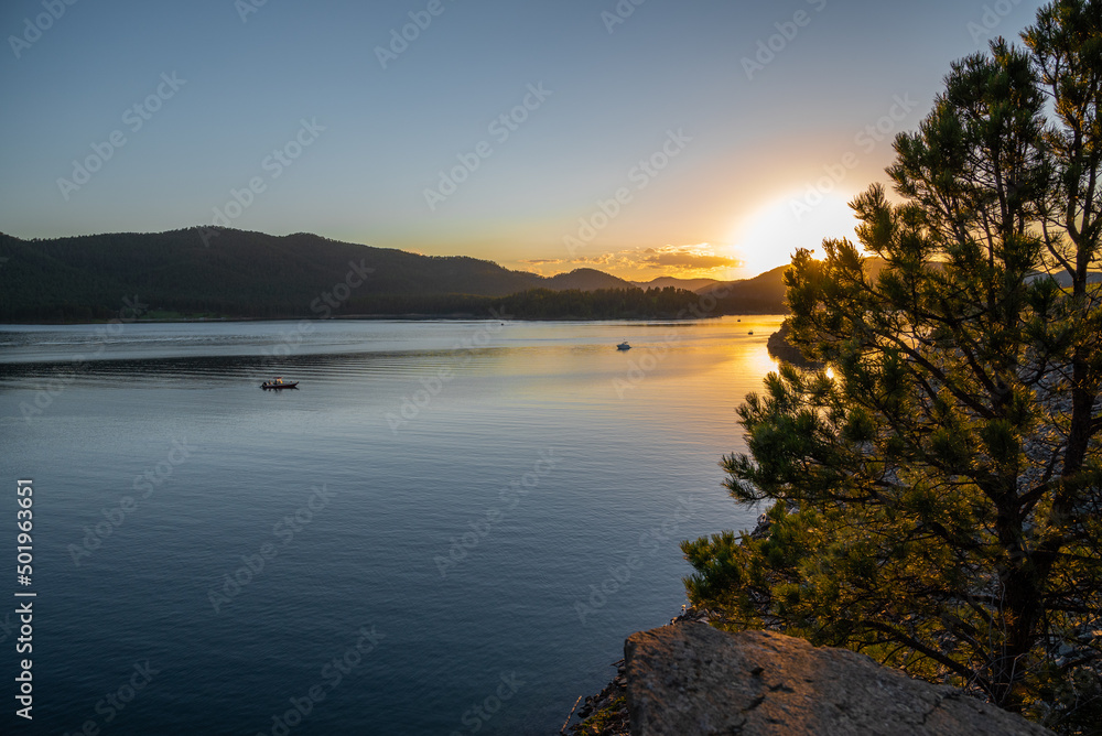 sunset over the lake with boats
