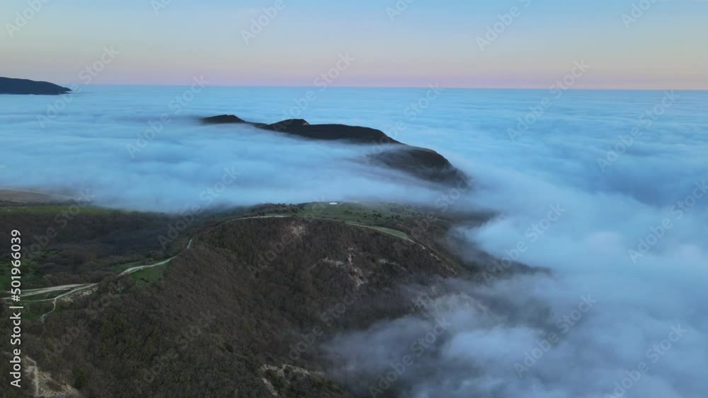 Aerial view with creeping fog and mountains. Foggy spring weather Aerial view with creeping fog and mountains. Foggy spring weather