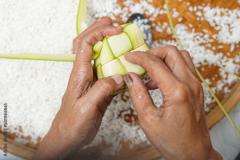 The process of making ketupat is a traditional food during Eid. Put the ...