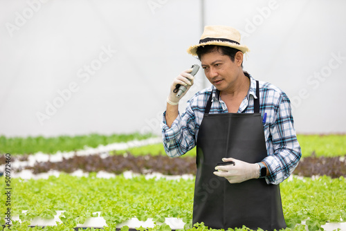 senior farmer holding soil thermometer for measure organic vegetables in hydroponic farm