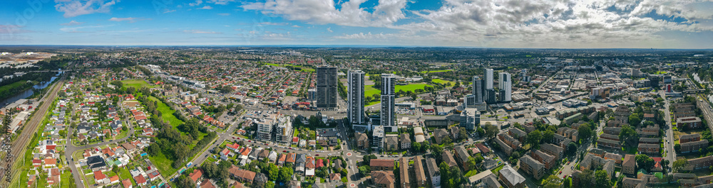 Fototapeta premium Panoramic aerial drone view of Liverpool in Greater Western Sydney, New South Wales, Australia looking west showing the high rise residential apartments