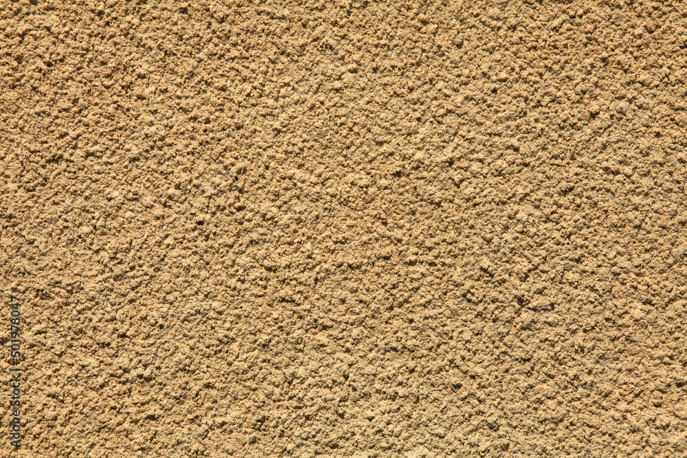 Beige wall texture, background. Decor of yellowish textured coating. Structural plaster, rough, uneven surface in beige color. Modern exterior cladding of multi-story buildings Beige wall texture, background. Decor of yellowish textured coating. Structural plaster, rough, uneven surface in beige color. Modern exterior cladding of multi-story buildings