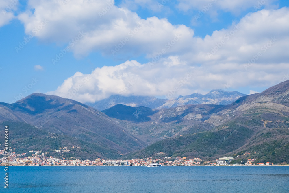view of the Kotor bay, Montenegro among mountains and clouds in blue sky. beautiful panorama coastline landscape. travel destination