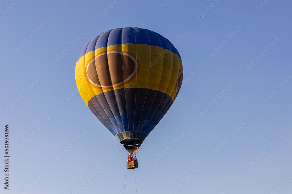 Hot air balloon flying over the Nur-Sultan on a cloudless summer's day. Hot air balloon flying over the Nur-Sultan on a cloudless summer's day.
