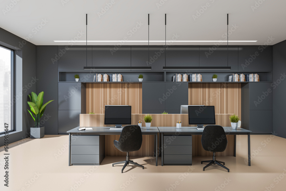 Front view on dark office interior with tables with desktops