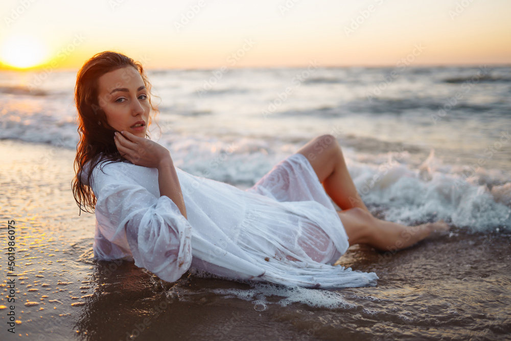 Stylish woman in elegant white dress posing near the sea. Summer time. Travel, weekend, relax and lifestyle concept. Stylish woman in elegant white dress posing near the sea. Summer time. Travel, weekend, relax and lifestyle concept.