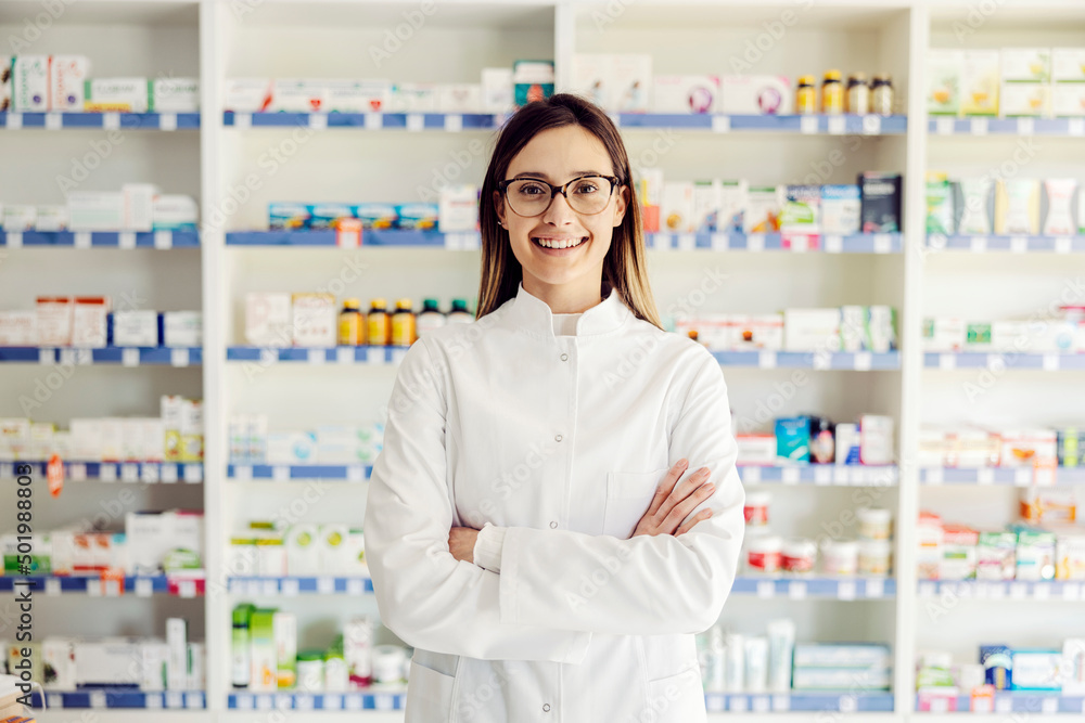 A successful young female pharmacist at pharmacy ready to help.