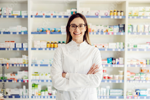 A successful young female pharmacist at pharmacy ready to help. photo