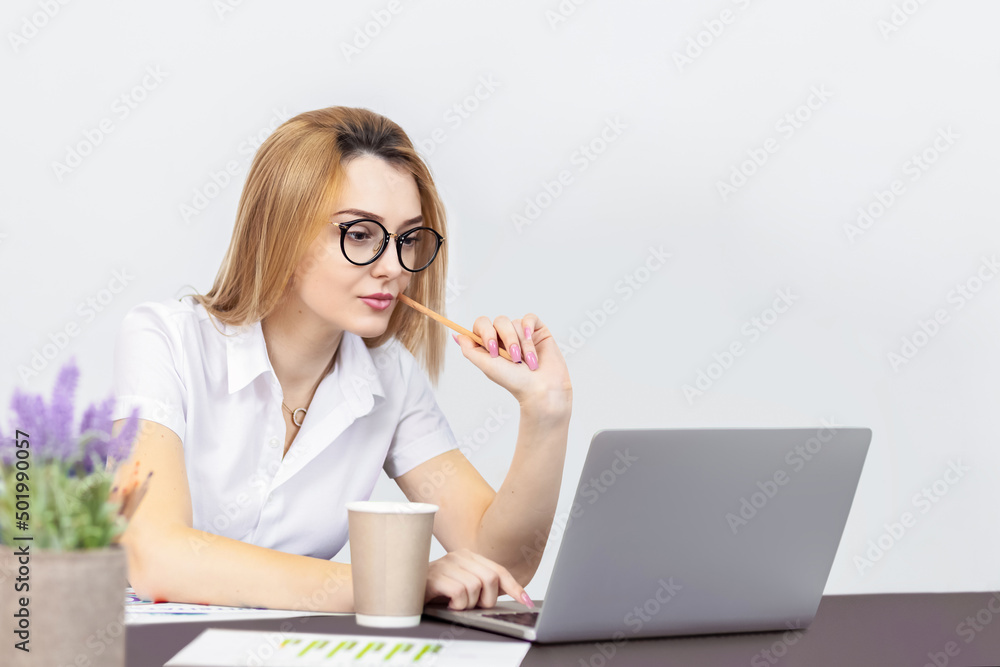 Young business woman working on laptop from office Young business woman working on laptop from office