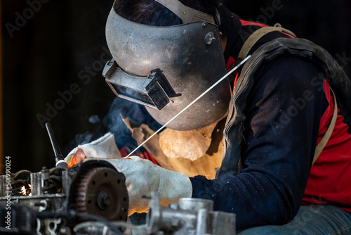 Konstfotografi Industrial welder worker metal welding steel works using argon arc welding machine to weld steel at factory, Metalwork manufacturing and construction maintenance