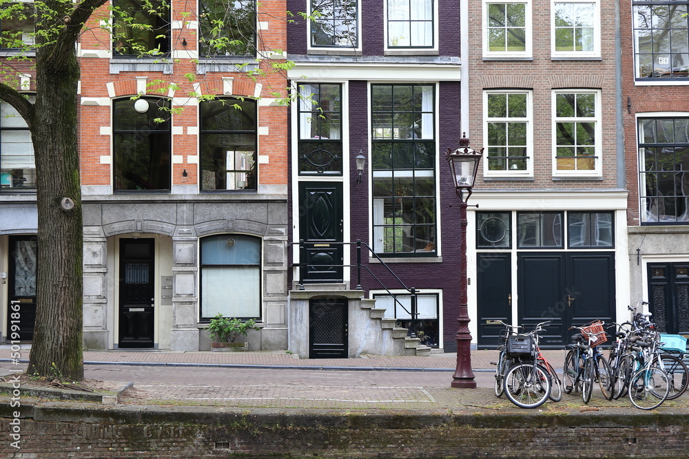 Amsterdam Reguliersgracht Street View with House Facades, Vintage Lamp Post and Parked Bicycles Close Up, Netherlands
