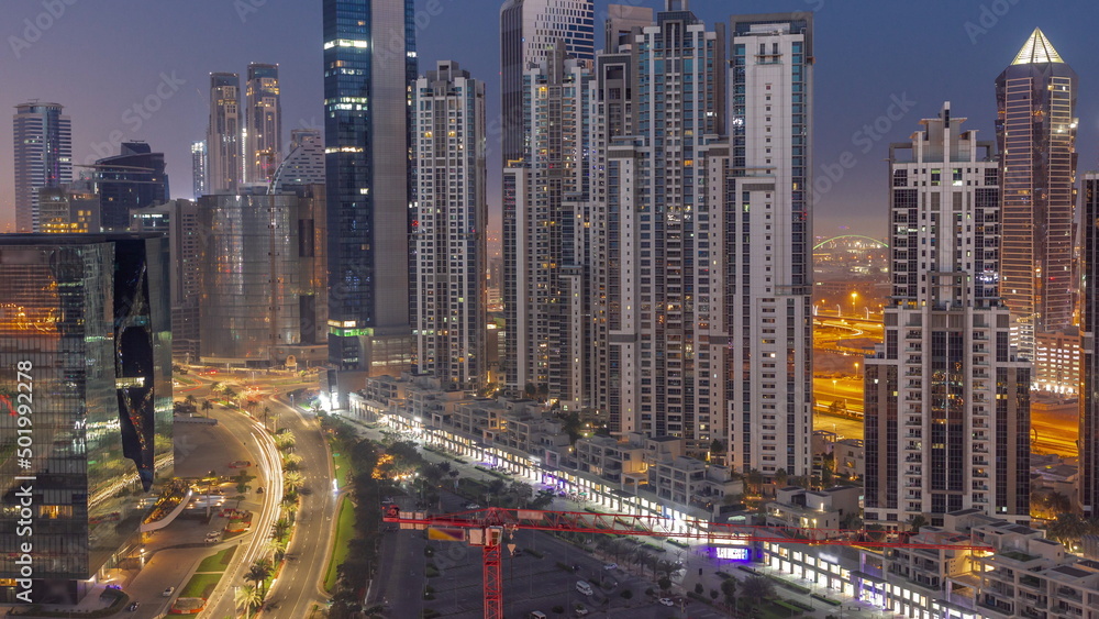 Bay Avenue with modern towers residential development in Business Bay aerial night to day timelapse, Dubai