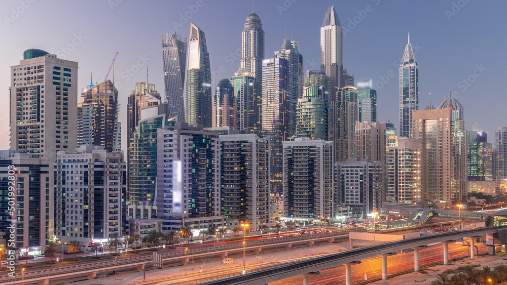 Dubai marina tallest block of skyscrapers day to night timelapse.