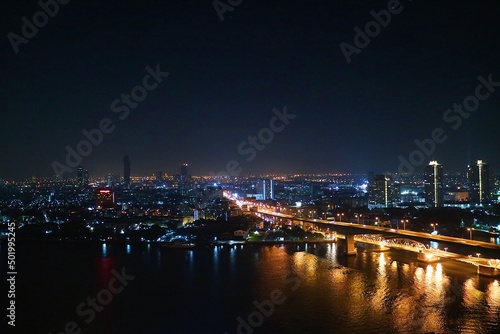 Urban night view next to the river and bridge piers © 11star