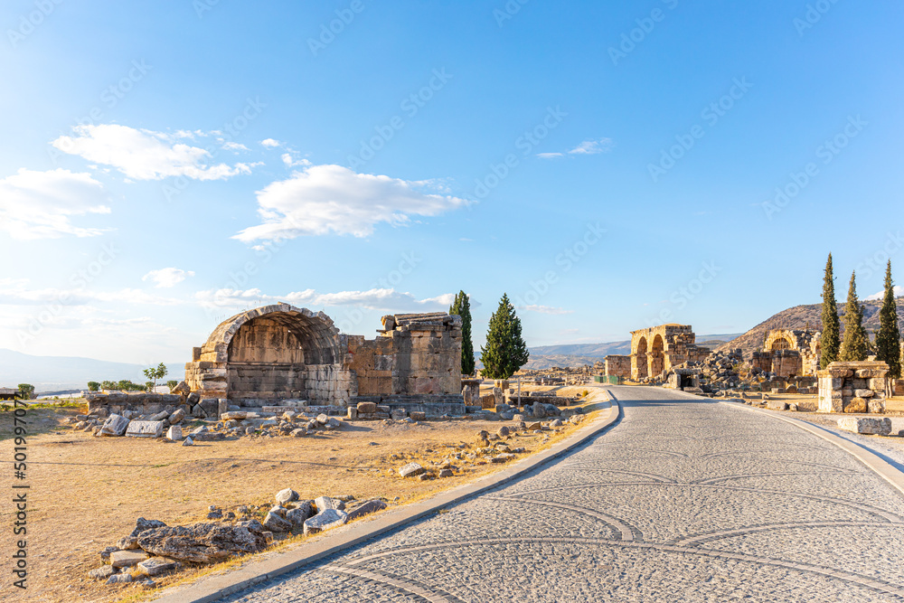 Alley and ruins of ancient buildings in the historic city of Pamukkale. Tourist attraction.
