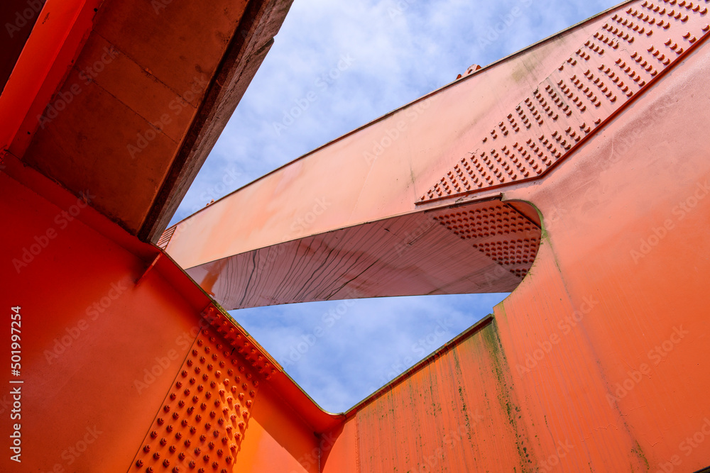 Close up part of modern orange steel bridge 