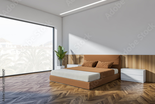 Corner view on bright bedroom interior with empty white wall