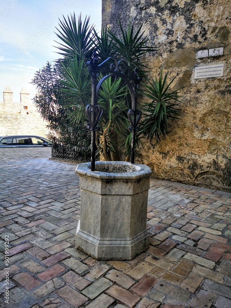 Drinking water well in a traditional spanish publo. brown stone square. no people. Drinking water well in a traditional spanish publo. brown stone square. no people.