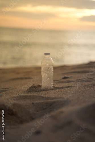 PET Plastic bottle trash on shore beach