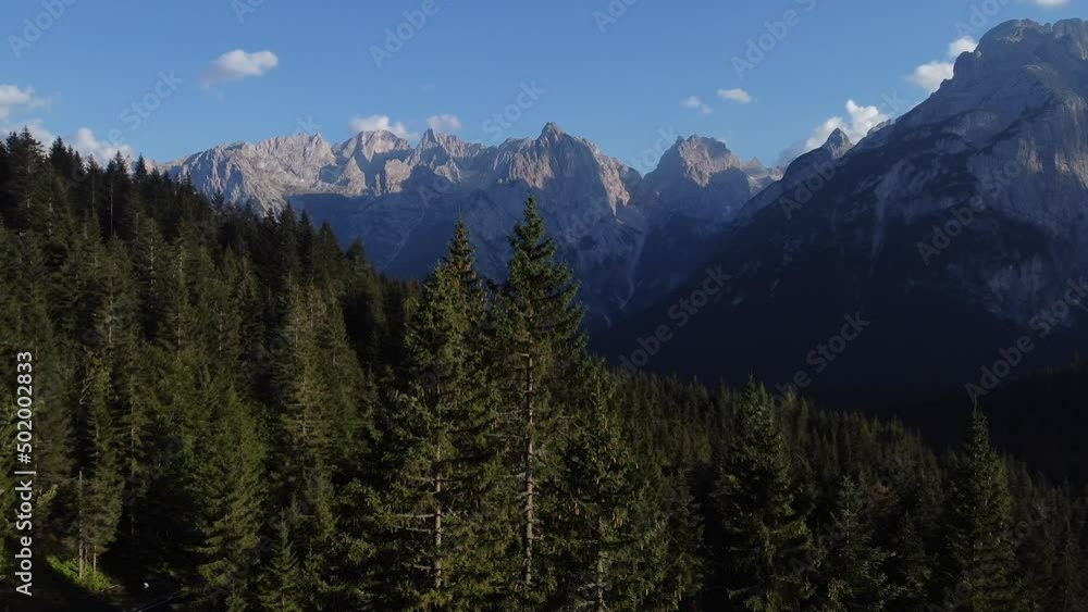 A beautiful drone shot flying in between trees of the dolomites in North Italy A beautiful drone shot flying in between trees of the dolomites in North Italy