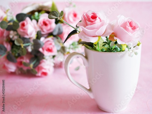White cup of tea with pink rose on pink background ,Valentine's day romantic ,Mother's day ,pretty background or wallpaper ,soft selective focus ,wedding card design ,coffee cup ,lovely love card 