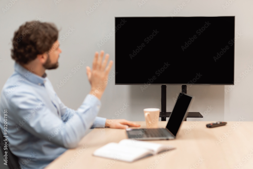 Business manager having web call waving at monitor mockup Business manager having web call waving at monitor mockup