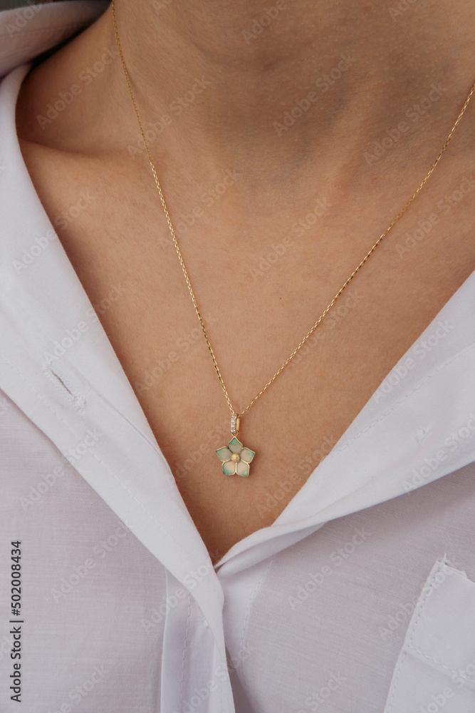Close-up young woman wearing gold chain necklace. Modern fashion details. minimalist lifestyle Close-up young woman wearing gold chain necklace. Modern fashion details. minimalist lifestyle