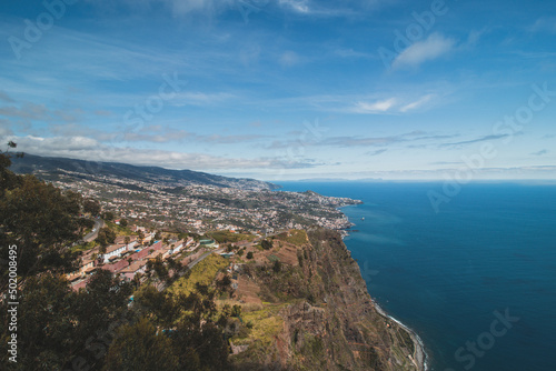 View from the Cabo Girao lookout, the highest cliff in Madeira, of the city of Funchal and the Atlantic Ocean. Aerial view in sunny weather on pure nature