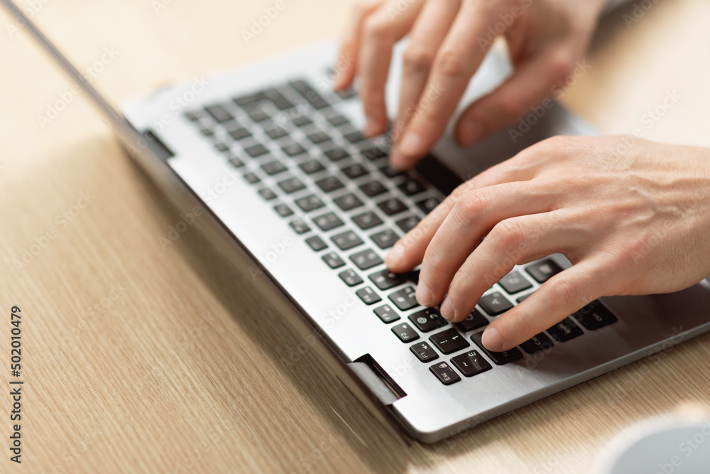 Business man using laptop sitting at desk in office Business man using laptop sitting at desk in office