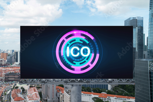 ICO hologram icon on billboard over panorama city view of Singapore at day time. The hub of blockchain projects in Southeast Asia. The concept of initial coin offering, decentralized finance