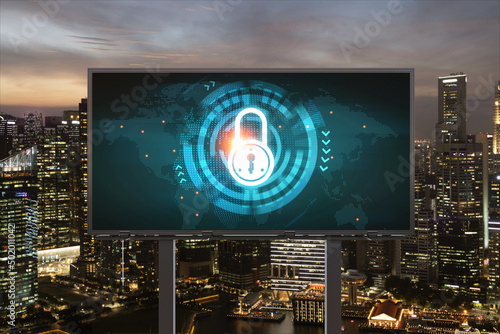 Padlock icon hologram on road billboard over panorama city view of Singapore at night to protect business, Southeast Asia. The concept of information security shields.