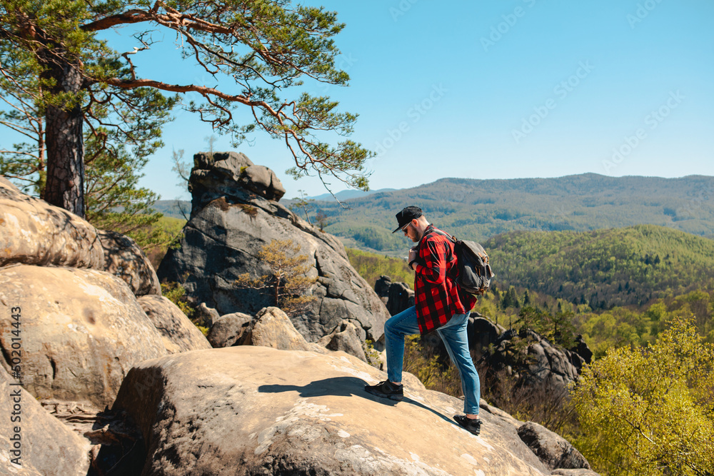 man hiker with backpack at dovbush rocks man hiker with backpack at dovbush rocks