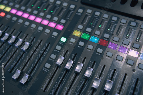 Professional audio mixing console. ​Mixer. Pro audio mixing board faders and knobs. Static shot of multi-track music recording equipment faders and sliders. 