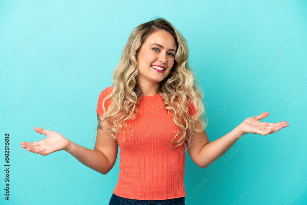Fototapeta premium Young Brazilian woman isolated on blue background happy and smiling