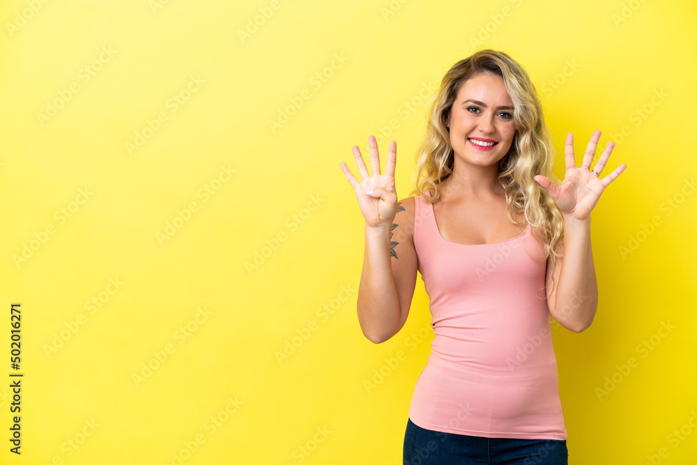 Young Brazilian woman isolated on yellow background counting nine with fingers Young Brazilian woman isolated on yellow background counting nine with fingers
