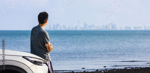 Fotobehang Asian man looking at the urban business skyline of financial district over the l