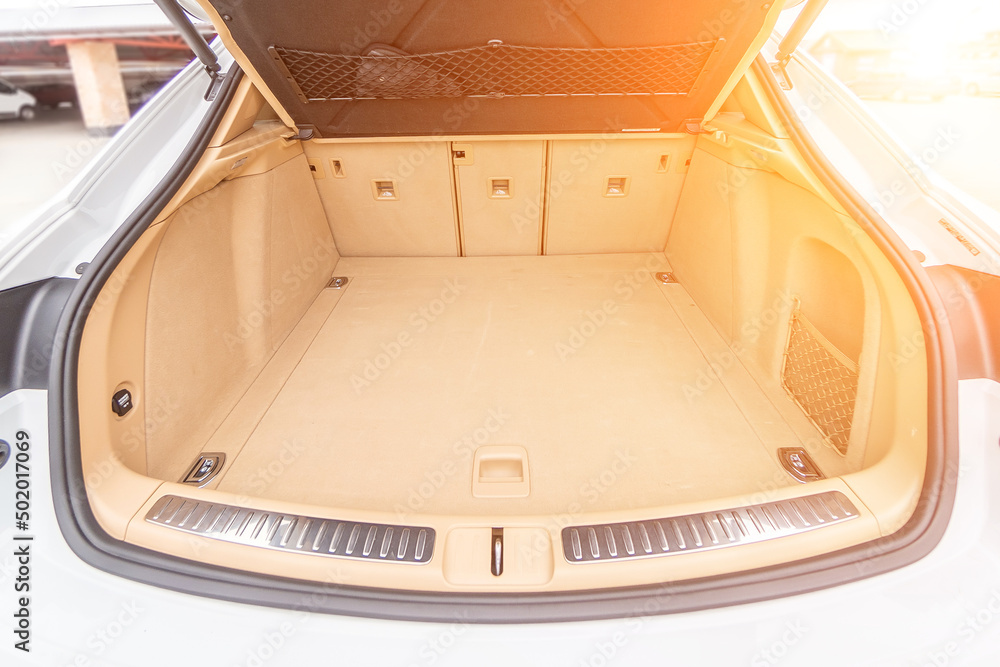 Car interior luxury. Beige comfortable seats, steering wheel, dashboard, climate control, speedometer, display, wood decoration light Car interior luxury. Beige comfortable seats, steering wheel, dashboard, climate control, speedometer, display, wood decoration light