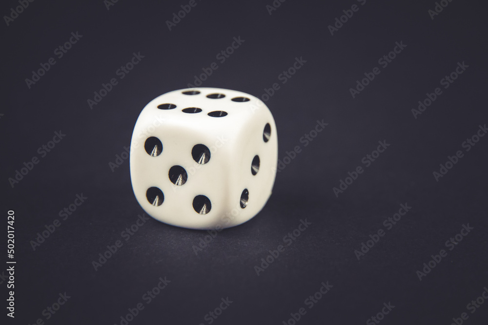White dice on black table background White dice on black table background