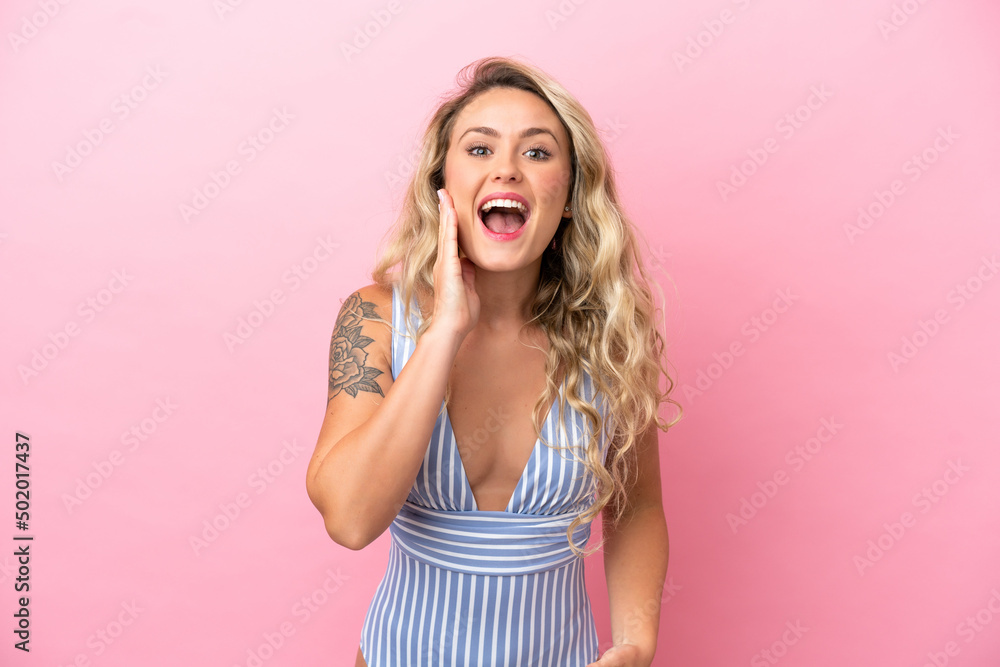 Young Brazilian woman in swimsuit in summer holidays isolated on pink background with surprise and shocked facial expression Young Brazilian woman in swimsuit in summer holidays isolated on pink background with surprise and shocked facial expression