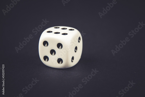 White dice on black table background