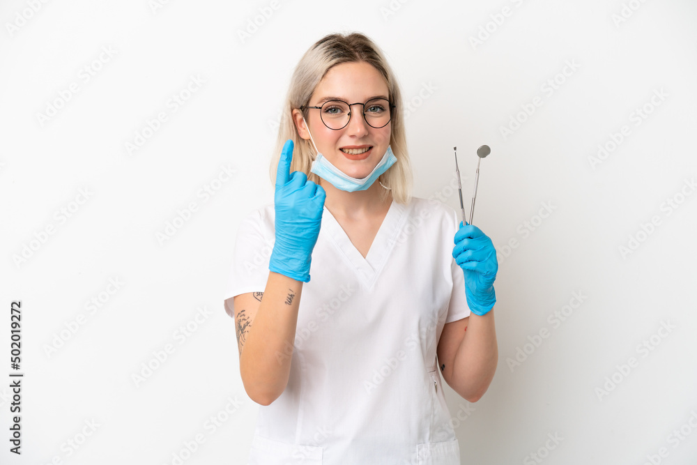 Dentist caucasian woman holding tools isolated on white background doing coming gesture Dentist caucasian woman holding tools isolated on white background doing coming gesture