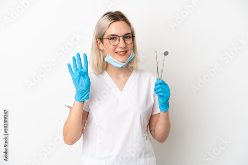 Dentist caucasian woman holding tools isolated on white background happy and counting four with fingers