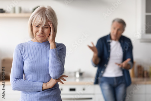 Mature lady crying, having quarrel with her husband